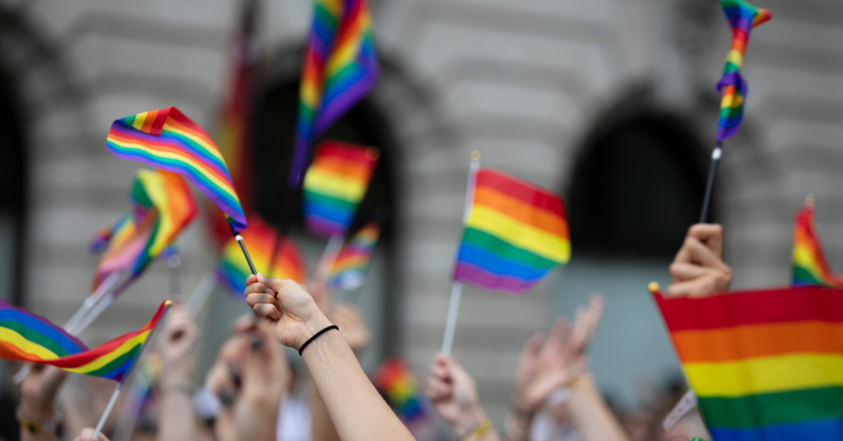 People waving Pride Flags