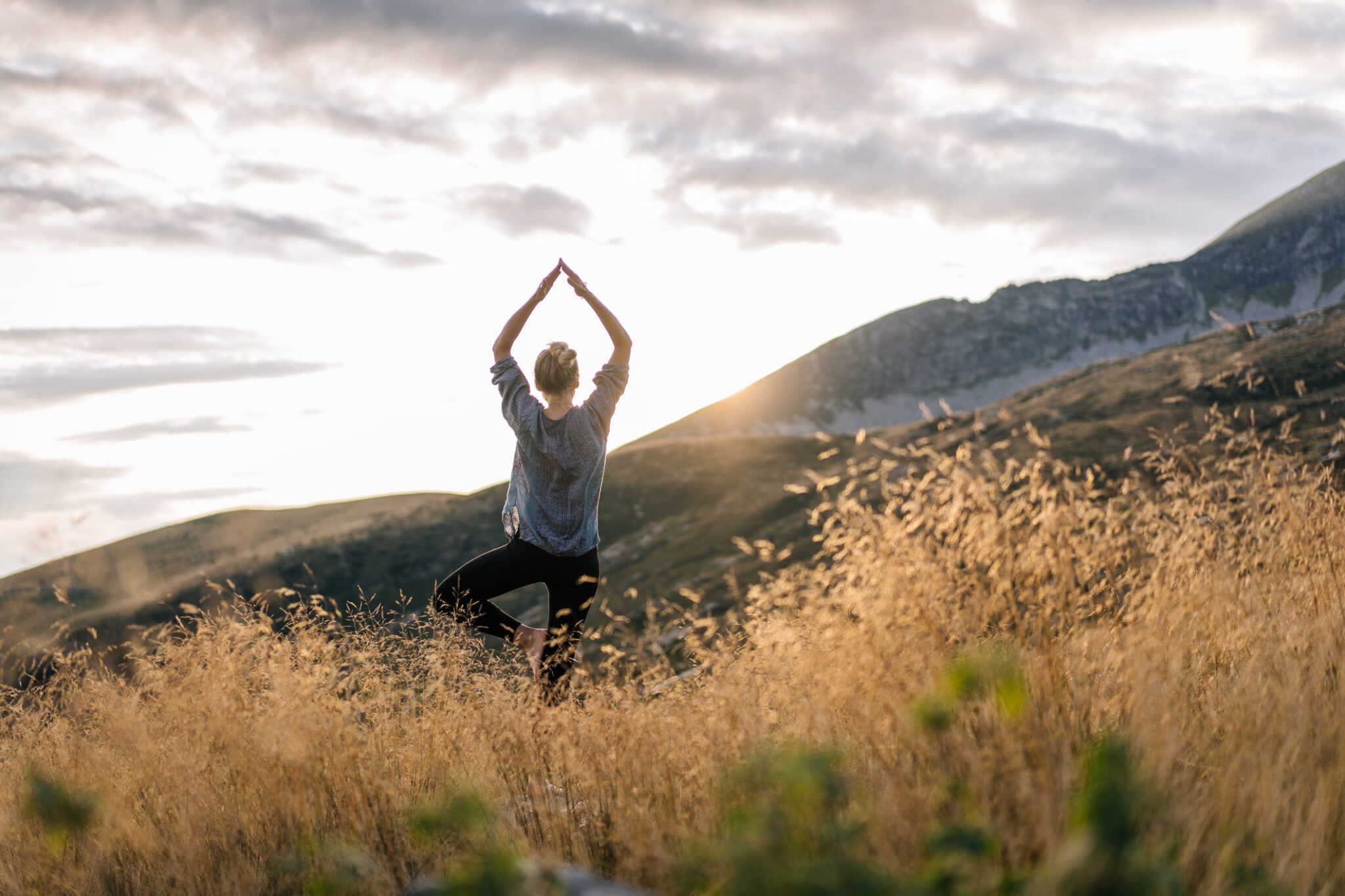 A person in a field expereincing life after a Colorado Mushroom Retreat